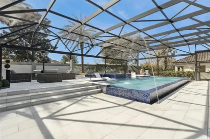 Pool deck with fountains under the screen enclosure