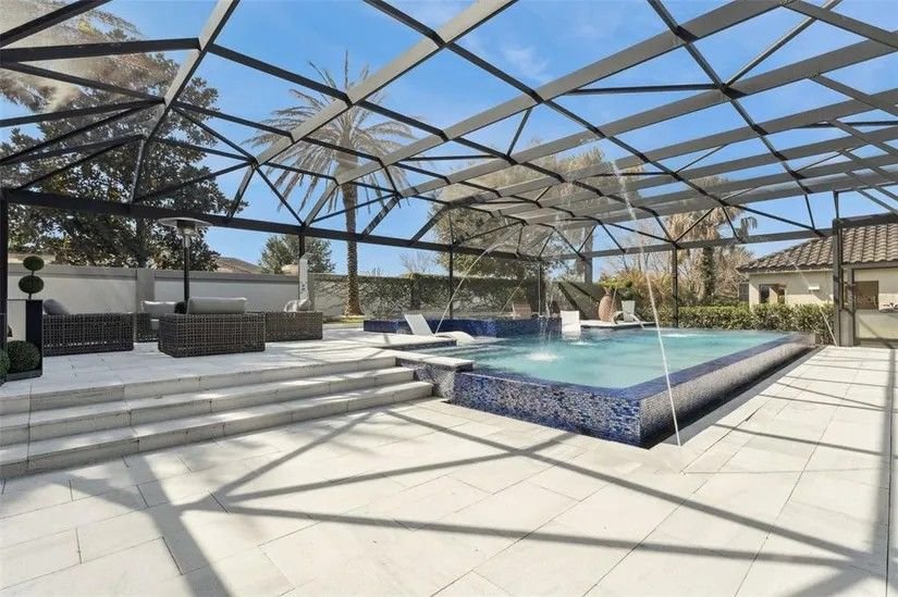 Pool deck with fountains under the screen enclosure